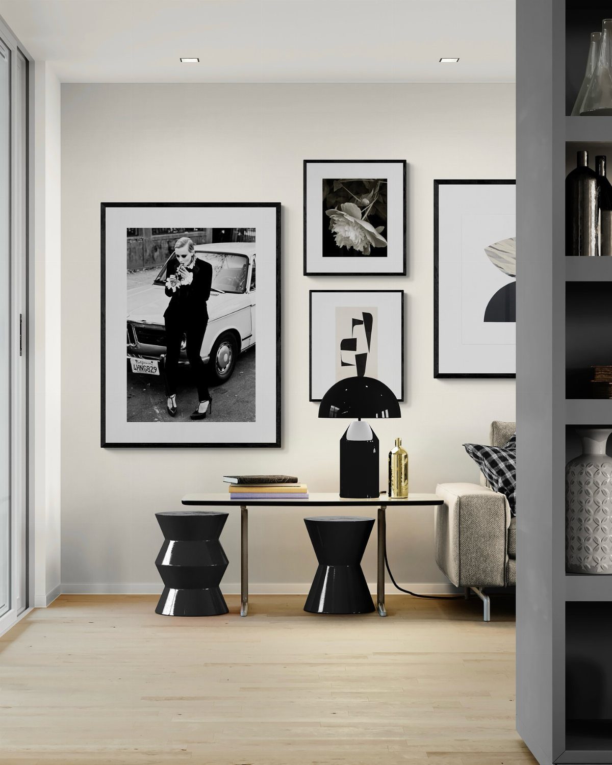 Black and white gallery wall with framed art above a modern console table.