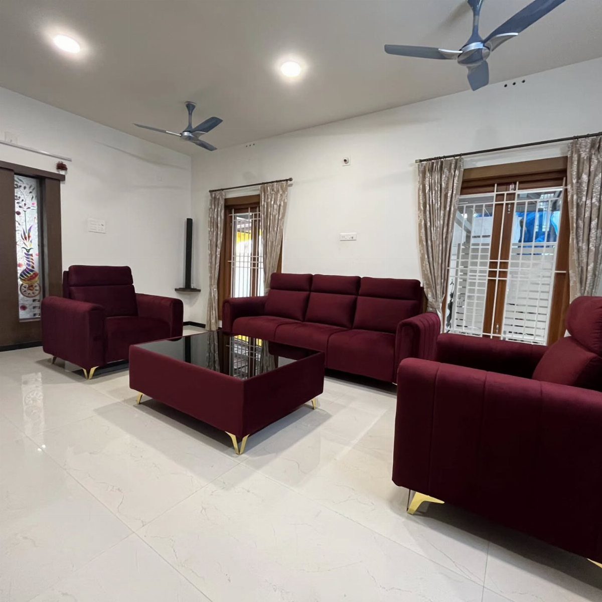 Deep red sofa set with matching coffee table in a bright white living room