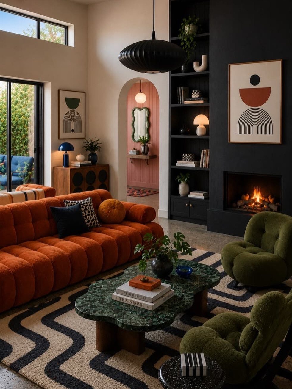 Orange-red tufted sofa in a modern living room with green chairs and fireplace