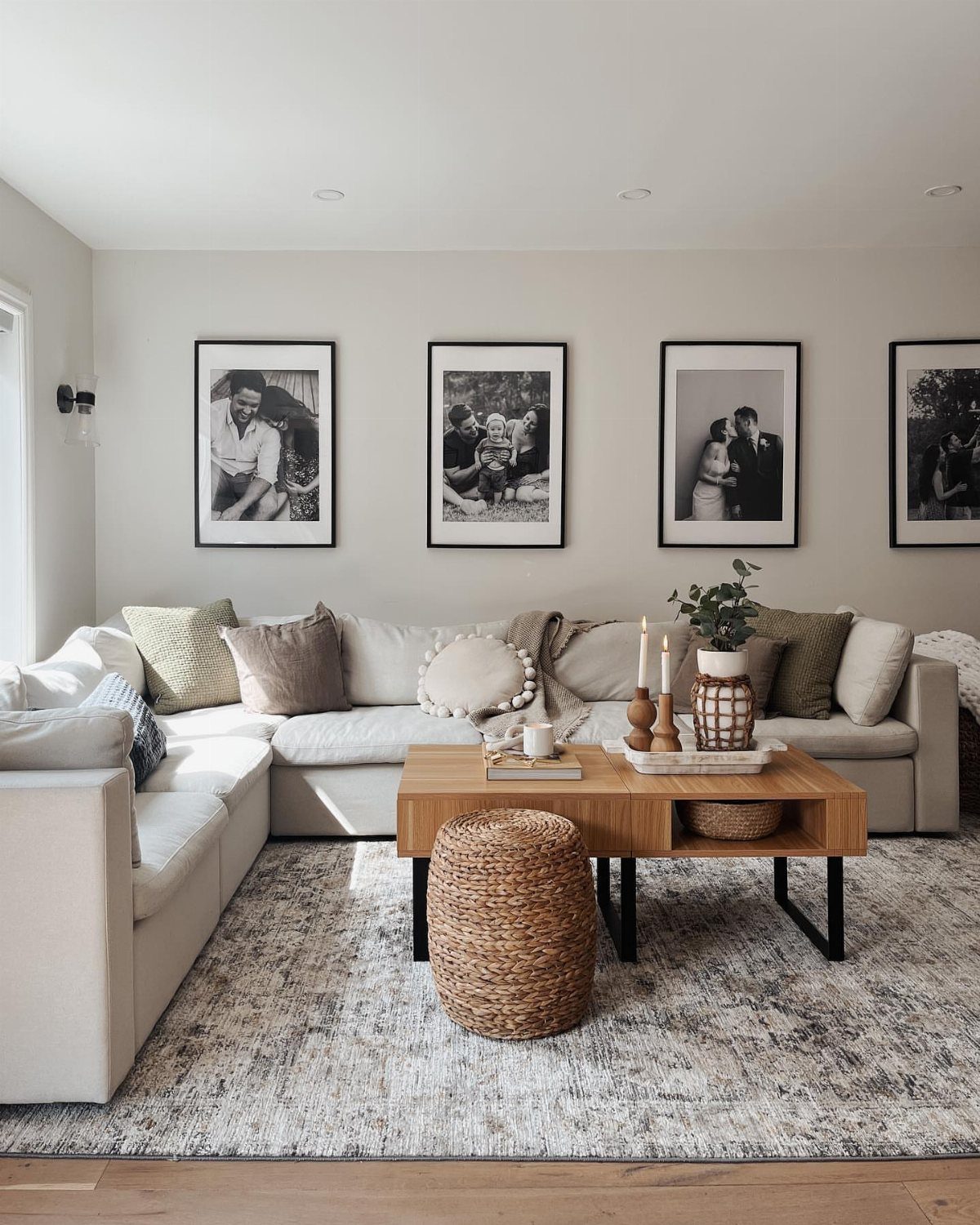 Living room with a grey patterned rug leaving hardwood floor visible around edges