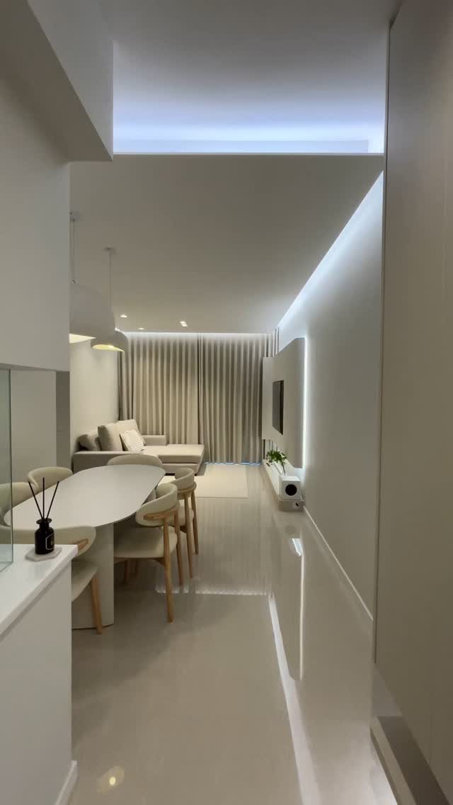 Modern narrow living room with a soft beige and white color palette.