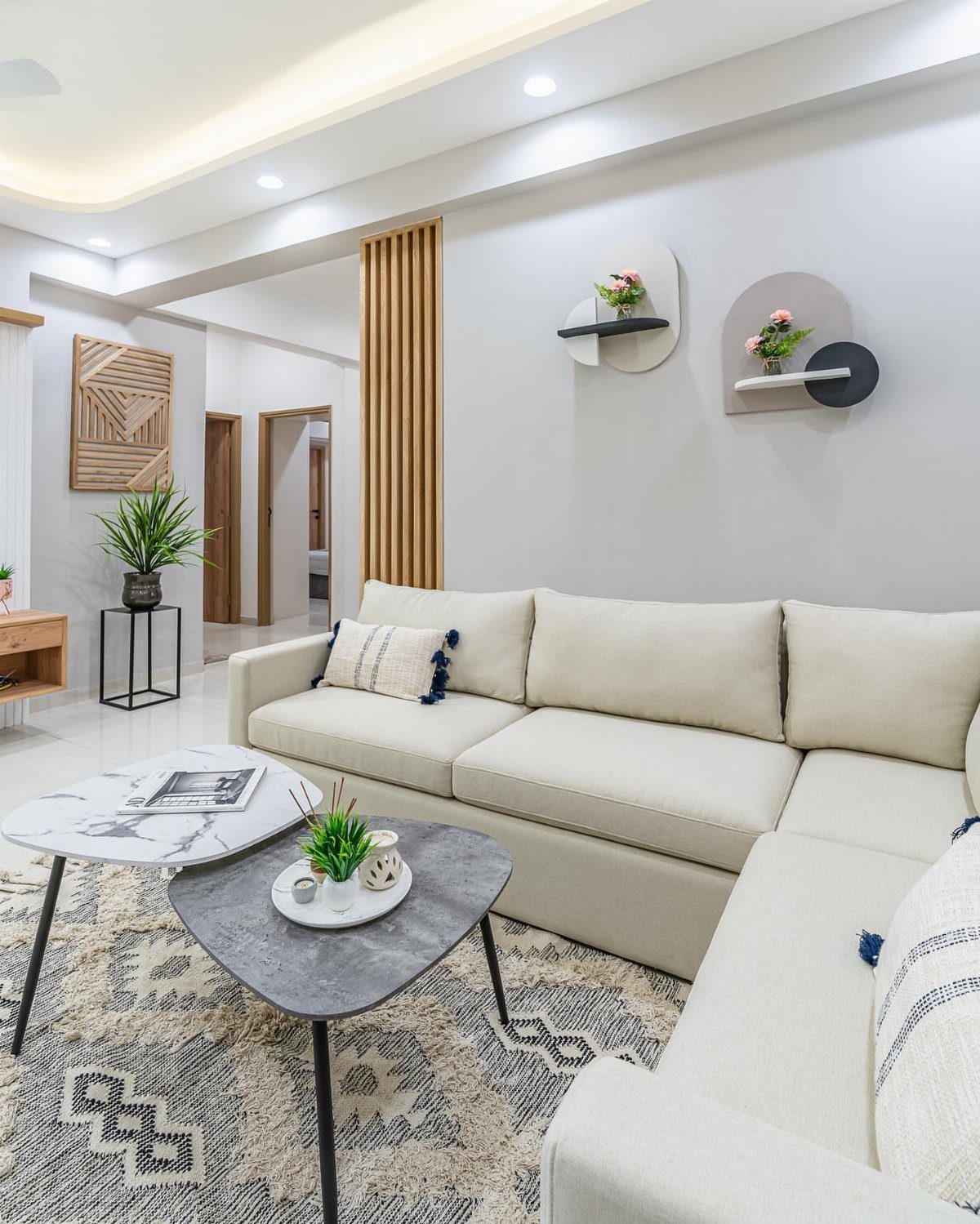 Cream sectional sofa and geometric coffee tables in a modern small living room