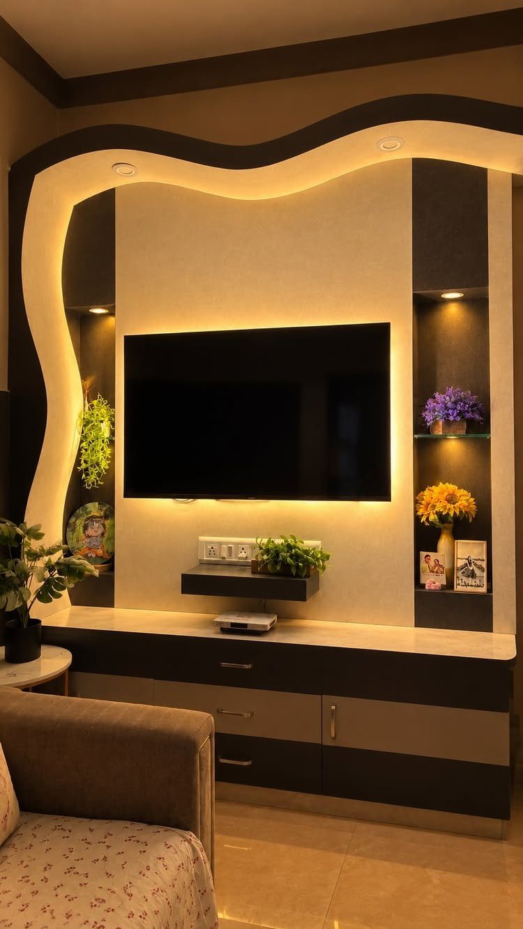 Wall-mounted TV with warm yellow LED backlight and a modern dark brown console.