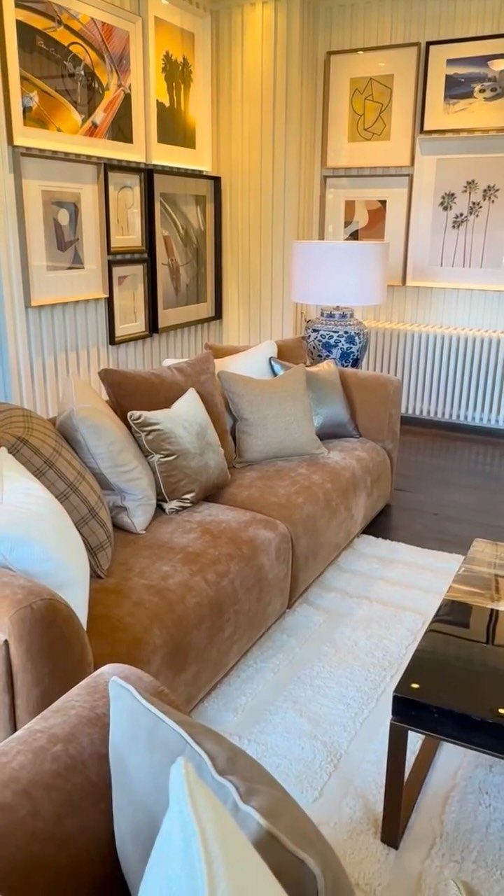 Brown suede sofa with beige and gold throw pillows in a modern living room
