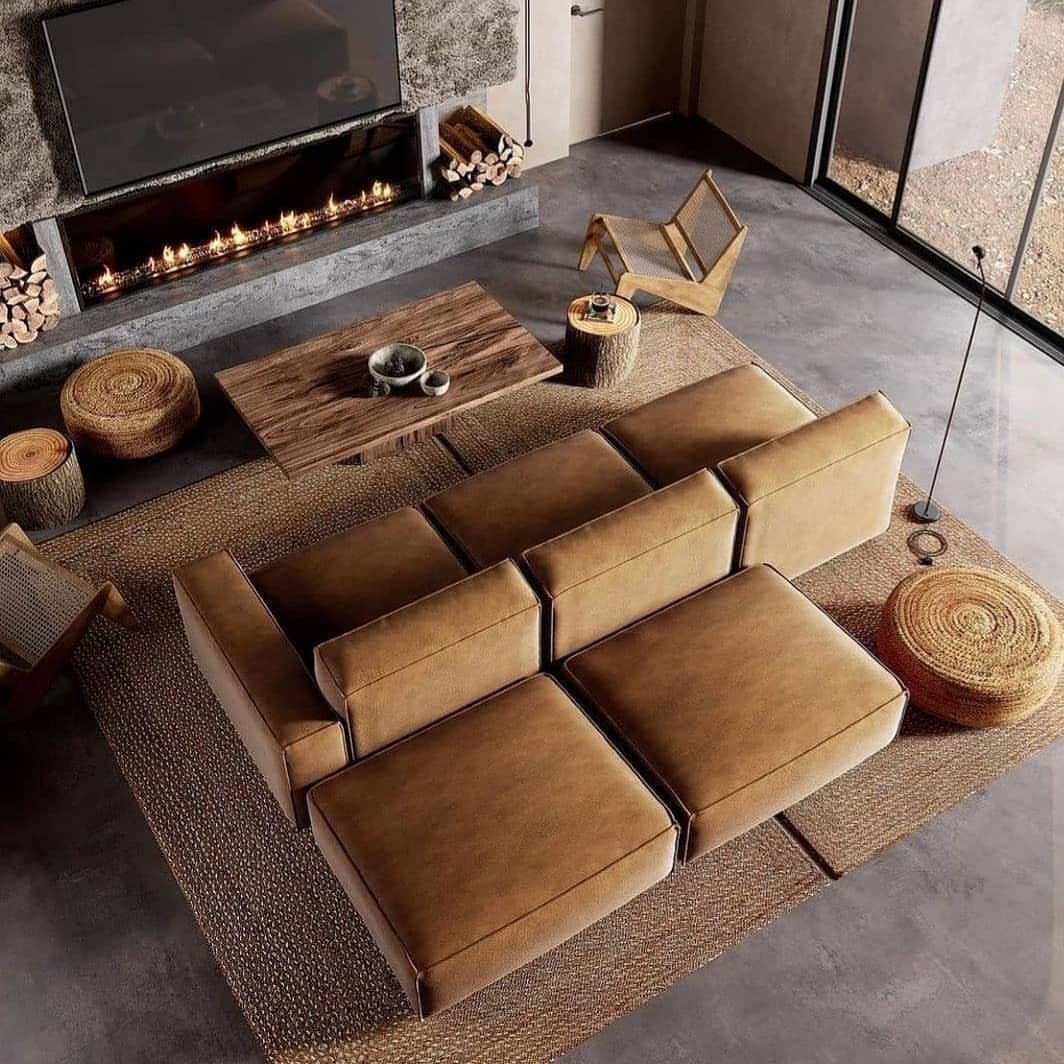 Tan modular sectional sofa on a brown rug in a modern living room