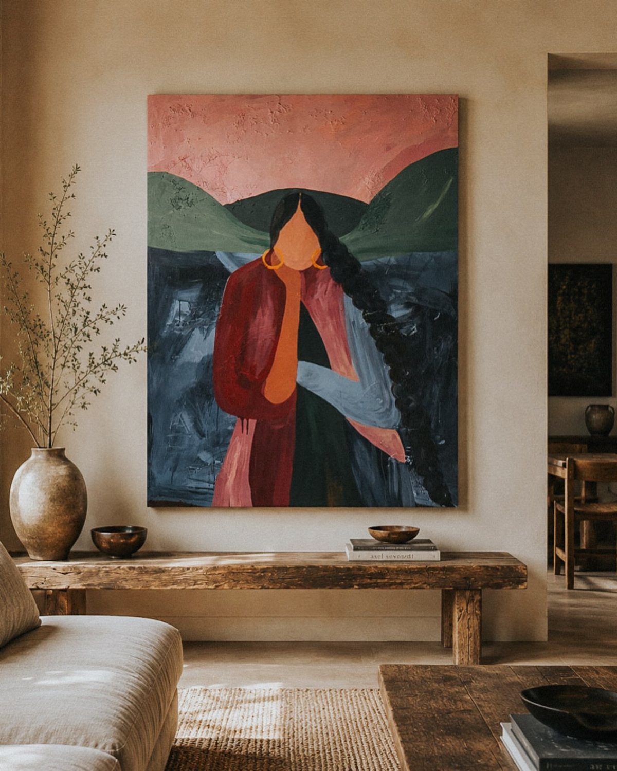 Large canvas painting of a woman hanging on a wall above a wooden bench.