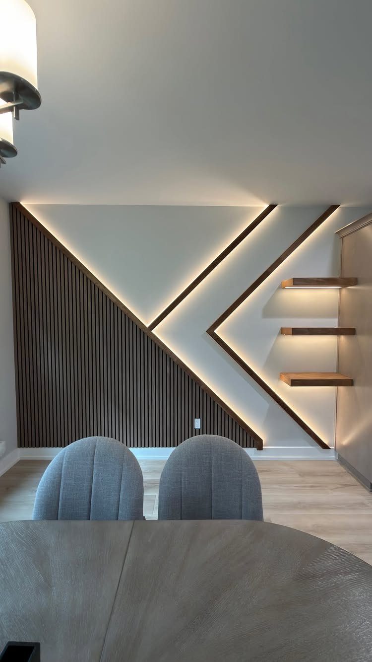 Modern accent wall with dark wood slats, diagonal LED lighting, and floating shelves.