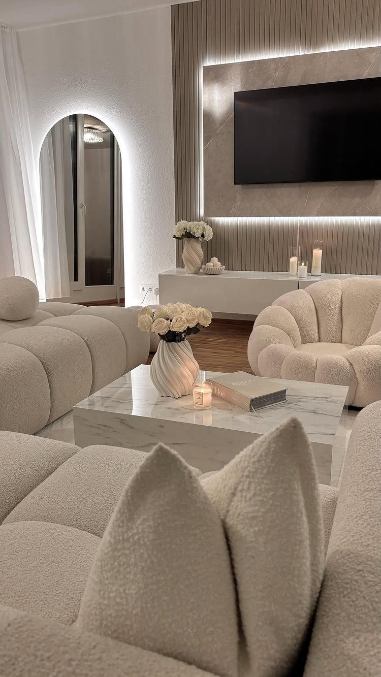 Cream textured sofas and marble coffee table in a neutral modern living room